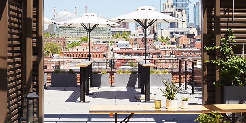 Skyline view of Kansas City with picnic tables and umbrellas in foreground