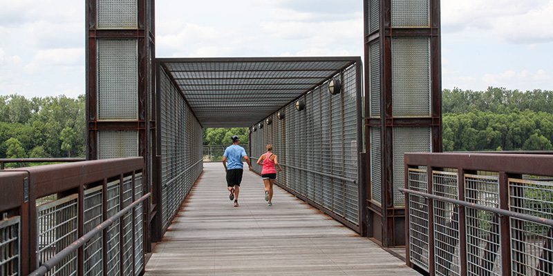 Two runners on the Town of Kansas Bridge